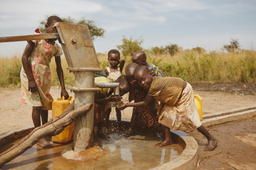 pexels photo 28101466 28101466 Group of children gathering water from a well in Kitgum, Uganda.
